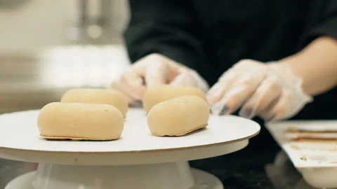 Female baker is working with cakes in kitchen pastry shop. Stock Footage 90229220