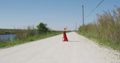 Female ballet dancer performing her routine on a country road Stock Footage 107645378