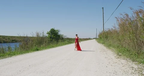 Female ballet dancer performing her routine on a country road Stock Footage 107645779