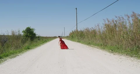 Female ballet dancer performing her routine on a country road Stock Footage 107646437