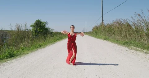 Female ballet dancer performing her routine on a country road Stock Footage 107649747