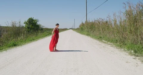 Female ballet dancer performing her routine on a country road Stock Footage 107652377