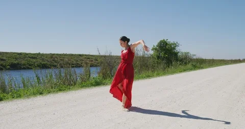 Female ballet dancer performing her routine on a country road Stock Footage 107652912