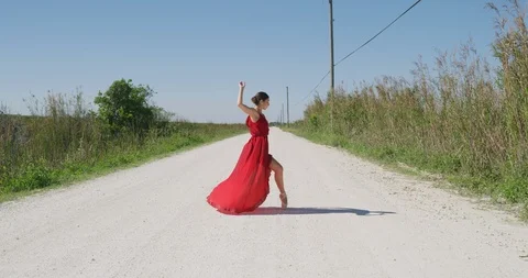 Female ballet dancer performing her routine on a country road Stock Footage 107653480