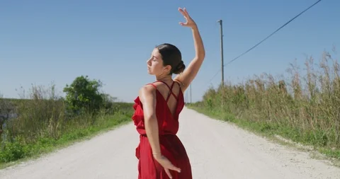 Female ballet dancer performing her routine on a country road Stock Footage 107654733
