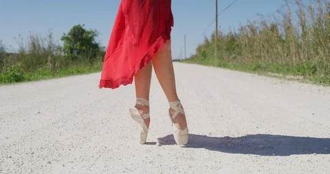 Female ballet dancer performing her routine on a country road Stock Footage 107656131
