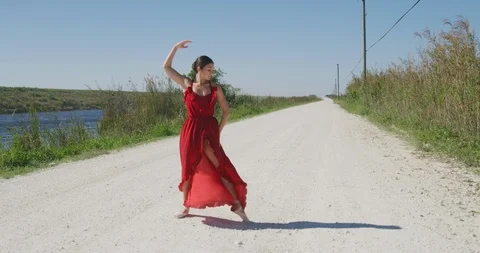 Female ballet dancer performing her routine on a country road Stock Footage 107656682