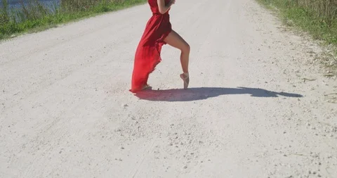 Female ballet dancer performing her routine on a country road Stock Footage 107657359