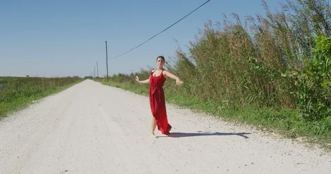 Female ballet dancer performing her routine on a country road Stock Footage 107664480