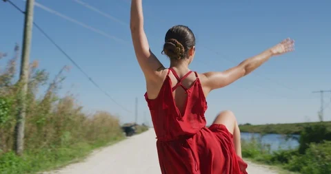 Female ballet dancer performing her routine on a country road Stock Footage 107665264