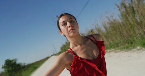 Female ballet dancer performing her routine on a country road Stock Footage 107684036