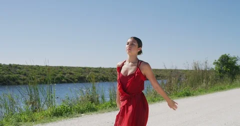 Female ballet dancer performing her routine on a country road Stock Footage 107686576