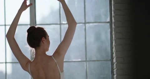 Female ballet dancer practicing in a studio, doing hand moves. Graceful and Stock-Footage 154775675