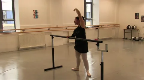 Female Ballet Dancer Using The Studio Ballet Barre for exercises Stock Footage 55337774