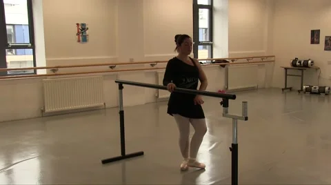 Female Ballet Dancer Using The Studio Ballet Barre for exercises Stock Footage 55337960