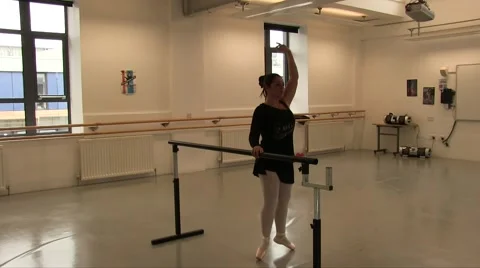 Female Ballet Dancer Using The Studio Ballet Barre for exercises Stock Footage 55338073