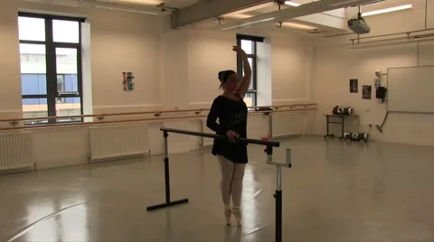 Female Ballet Dancer Using The Studio Ballet Barre for exercises Stock Footage 55339486