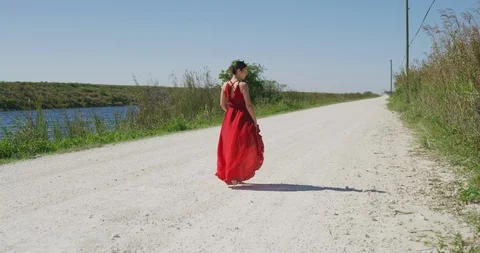 Female ballet dancer walking down country road Stock Footage 107658414