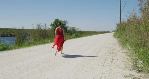 Female ballet dancer walking down country road Stock Footage 107659708