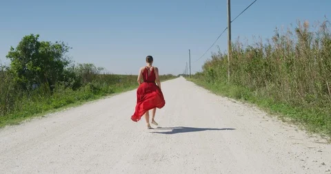Female ballet dancer walking down country road Stock Footage 107660149