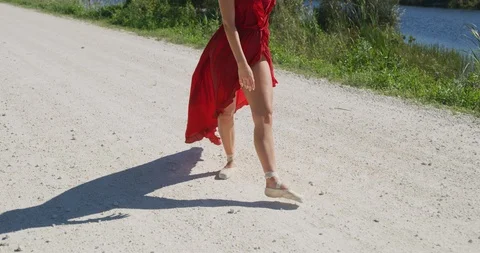 Female ballet dancer walking down country road Stock Footage 107670424