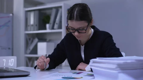 Female bank worker comparing data in graphs, satisfied with results, success Stock Footage 111904860