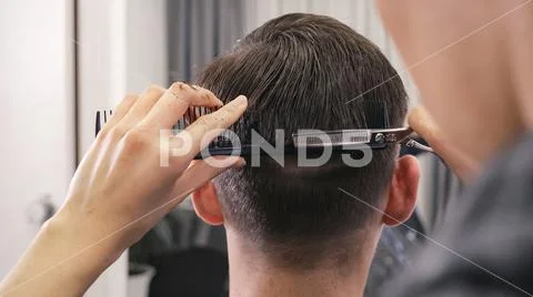 Female barber haircut doing male hair style Stock Photos