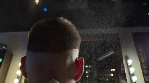 Female barber spraying a special solution on hair Video stock 337637378