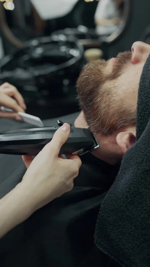 Female Barber Trimming Client Beard in Salon Stock-Footage 339769116
