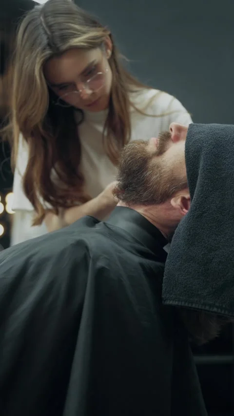 Female Barber Trimming Client Beard in Salon Video stock 340068889