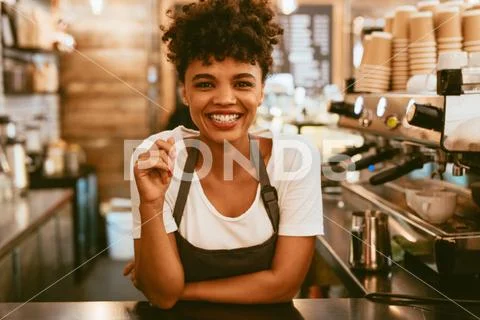 Female barista behind counter Stock Photos
