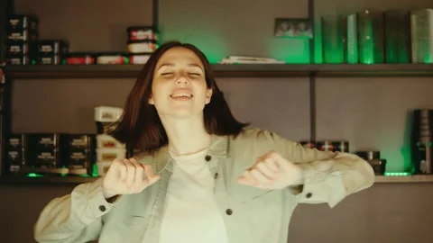 Female bartender is dancing behind the bar counter after her shift, showcasing Stock Footage 285089305