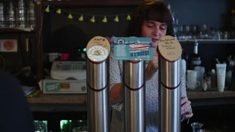 Female Bartender Pouring Beer From Craft Beer Taps Vídeo Stock 344890309