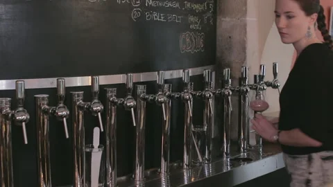 Female Bartender Pouring Craft Beer Sample at Taproom Service Counter Stock Footage 346147138