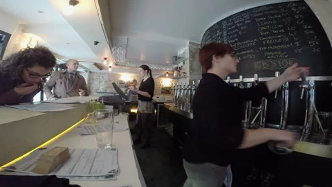 Female Bartender Pouring Drink at Craft Beer Bar Taproom Counter Wide Angle Stock Footage 346361274