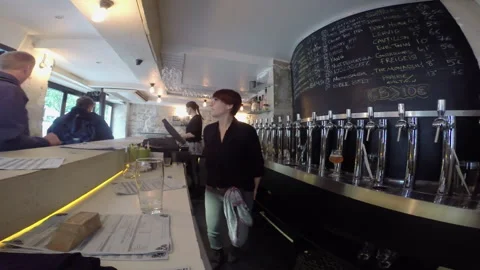 Female Bartender Serving Patrons at Paris Craft Beer Bar Taproom Counter Stock Footage 346354733