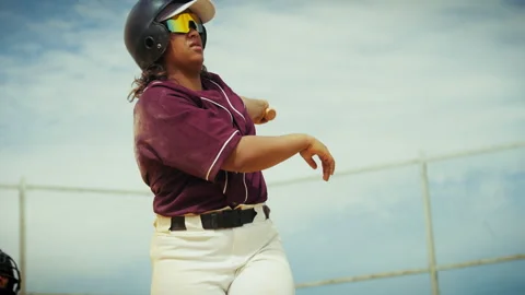 Female baseball player delivers a powerful hit at the plate Stock Footage 336945879