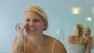 Female Beauty, Young Woman Applying Lotion On Face At Home Stock Footage