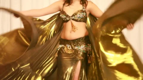 Female belly dancer perform in golden dress Stock Footage 8510153