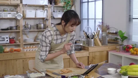 Female bending at the dining table is watching Stock Footage 154445373