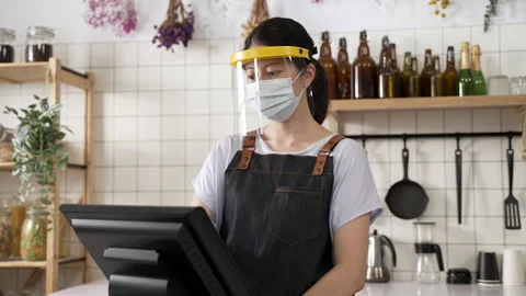 Female beverage shop worker is touching screen Stock Footage 205874467