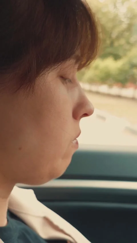 Female bite burger bun with cutlet enjoy fast food at car automobile side view Stock Footage 280365968