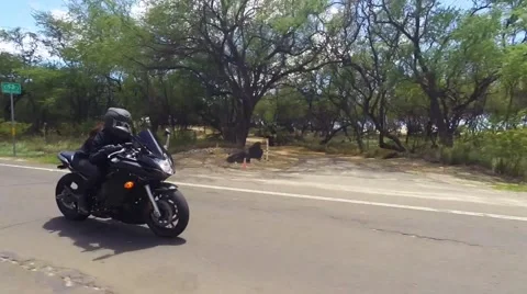 Female in black leather jacket and helmet on sport bike Stock Footage 63428362