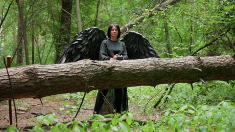 Female Black Witch Typing on Device in Forest Looking Thoughtful Stock Footage 326044049