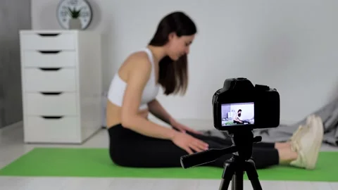 Female blogger recording practicing tutorial yoga exercise for people Stock Footage 151309159