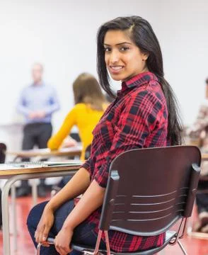 Female with blurred teachers students in classroom Stock Photos
