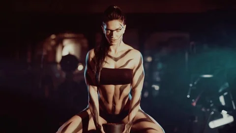 Female bodybuilder lifting chains isolated on dark Stock-Footage 71673312