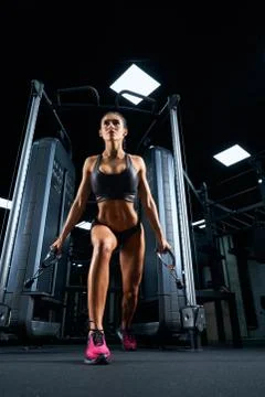 Female bodybuilder practicing cable crossover exercise. Stock Photos