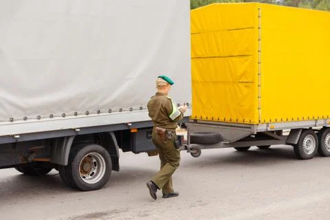 A female border guard checks the documents Stock Photos