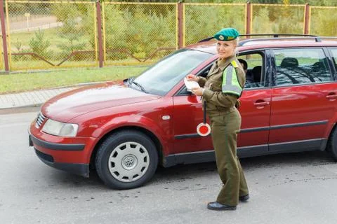 A female border guard checks the documents Stock Photos